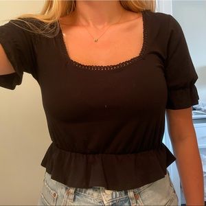 Black peplum style crop top with neckline detail